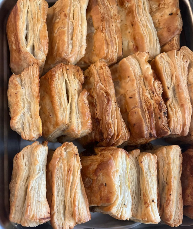 Tray of flaky Haitian pate patties fresh from the oven