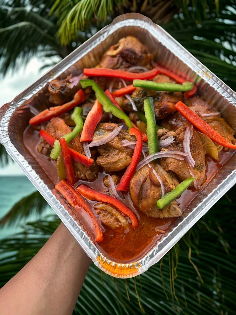 Haitian stewed chicken served beachside
