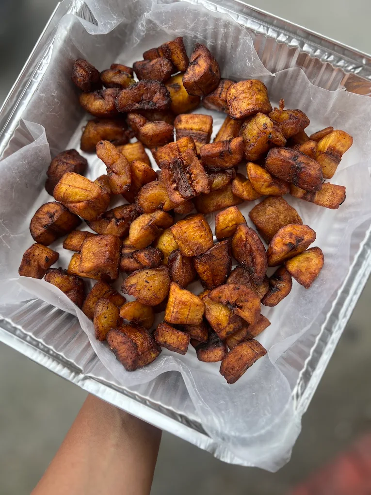 Golden fried sweet plantains in a takeout tray